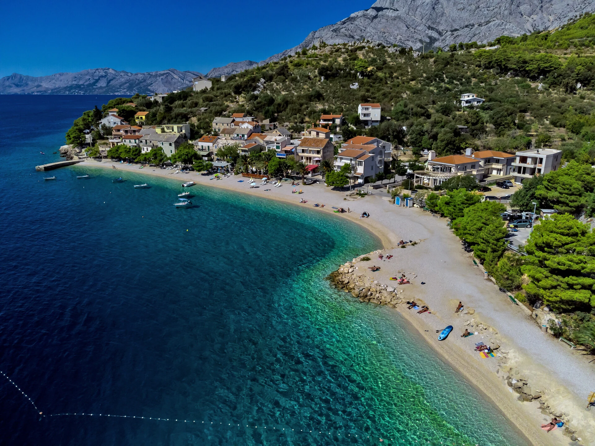 Aerial view of Bratus beach, village houses and Biokovo mountain